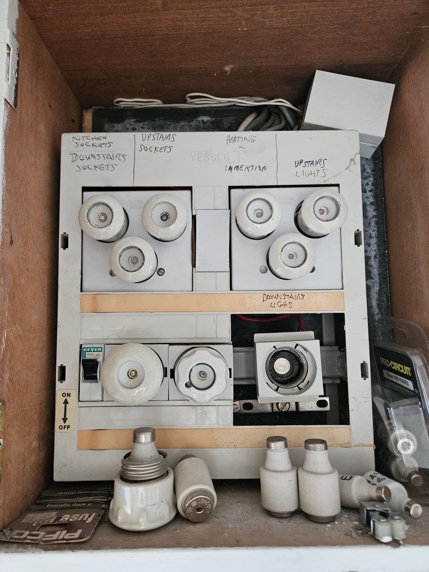 Legacy ceramic fuse board with missing front sections and visible internal wiring